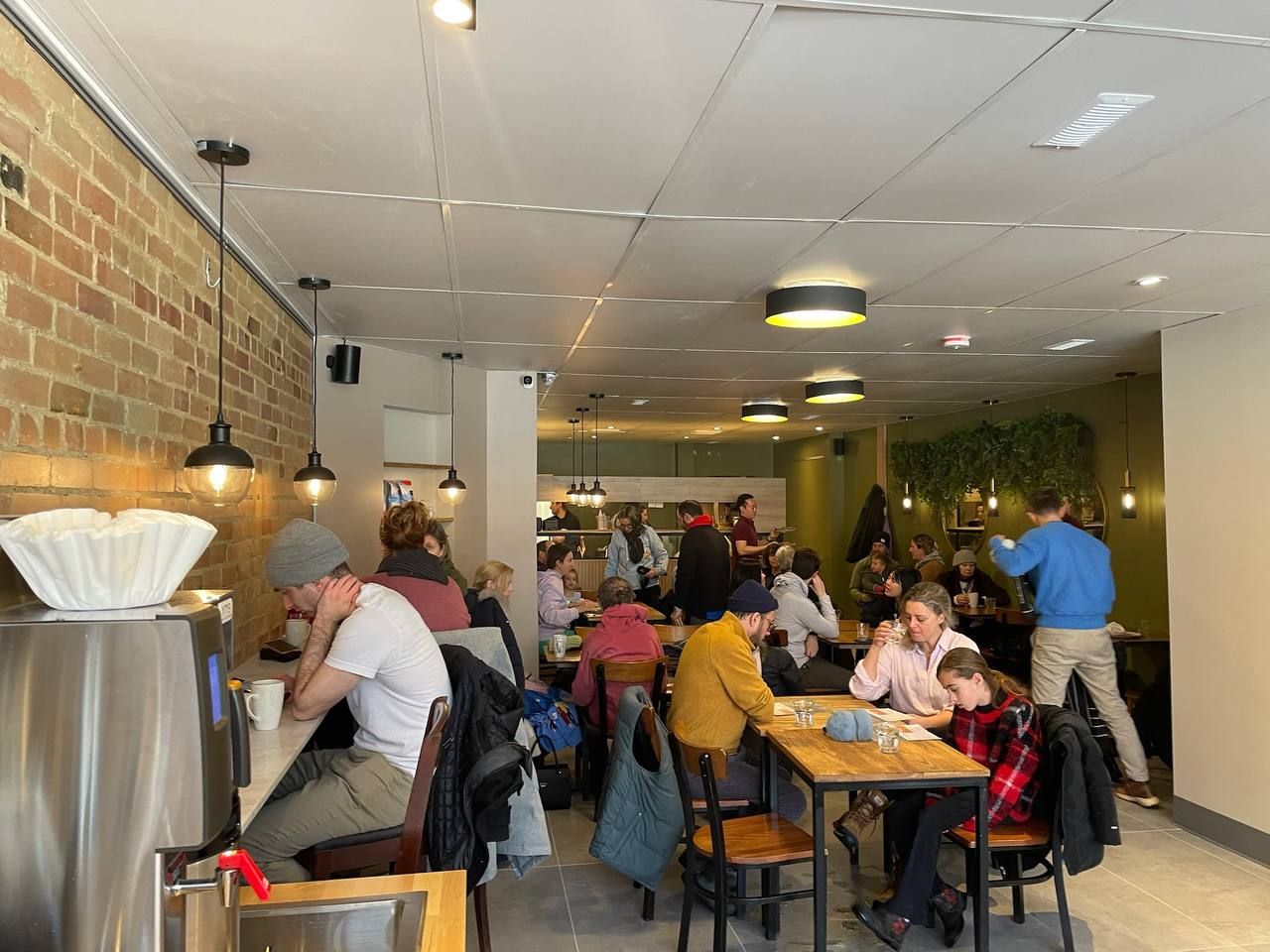 A full dining room at SAVA on Roncesvalles, with guests at every table
